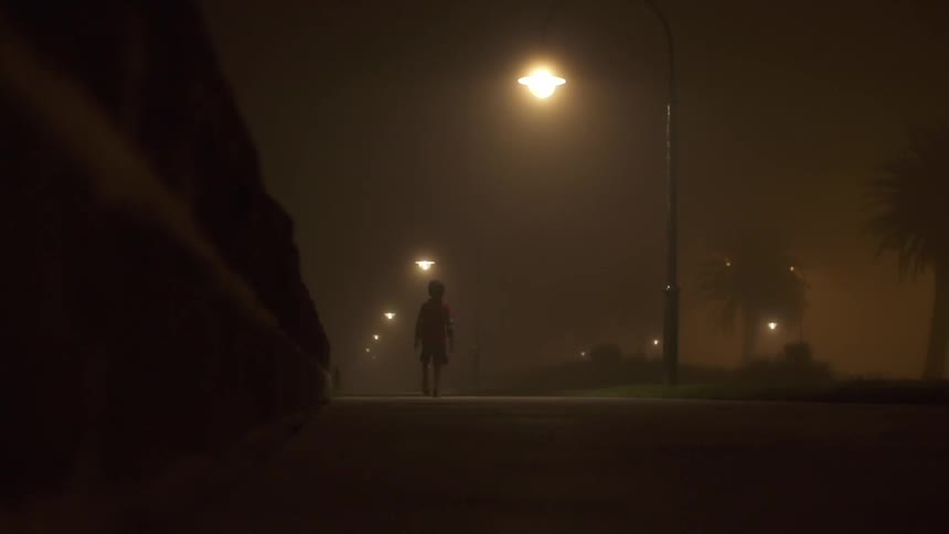 Street lamps shine down on child