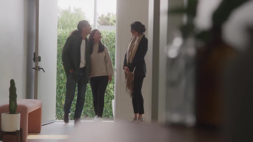 Real estate agent showing a house to a couple