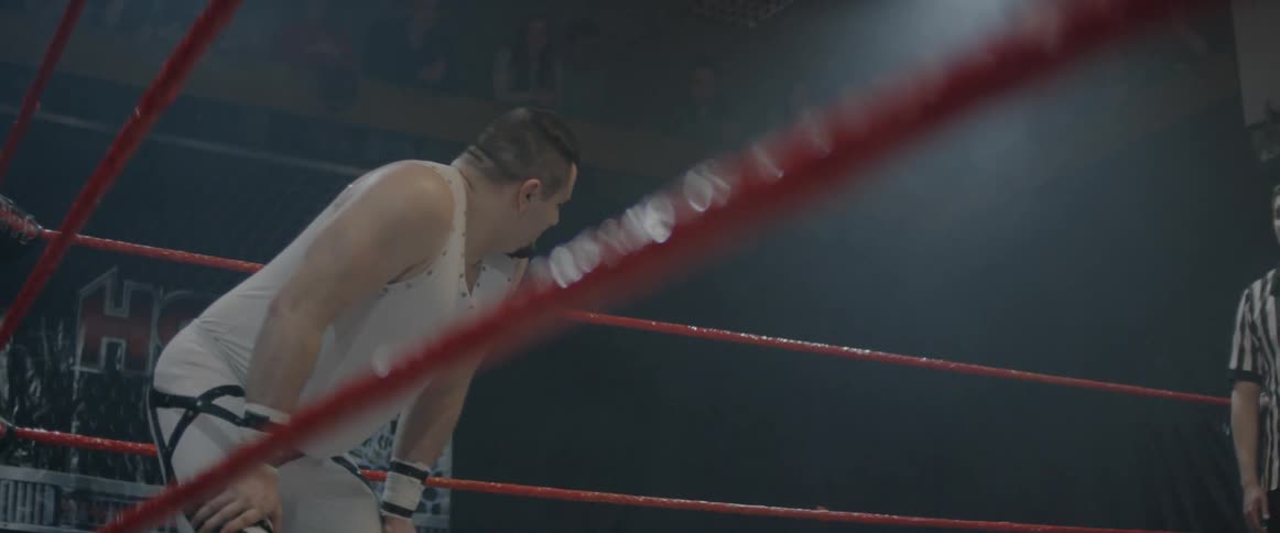 Man in a corner of a boxing ring looks behind him and back towards the other corner