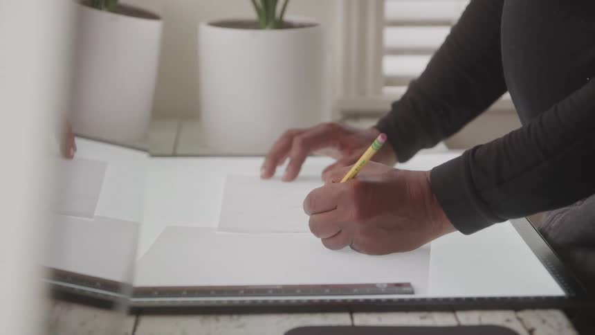 The woman is writing on her desk