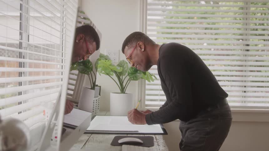 Man with a pen drawing on a monitor