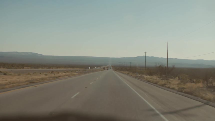 A vehicle travels on a remote road