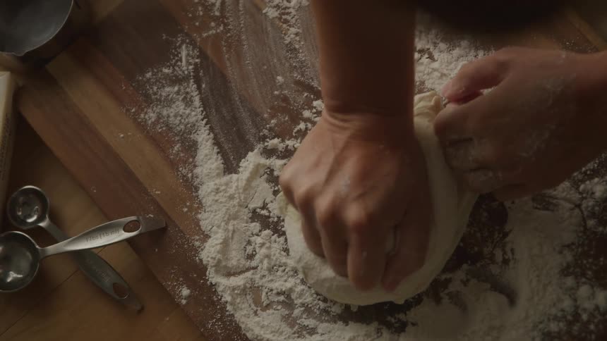 A person kneads dough