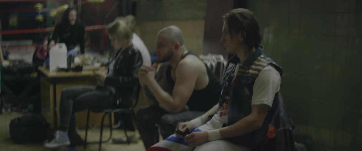 People are sitting in chairs in a hall waiting