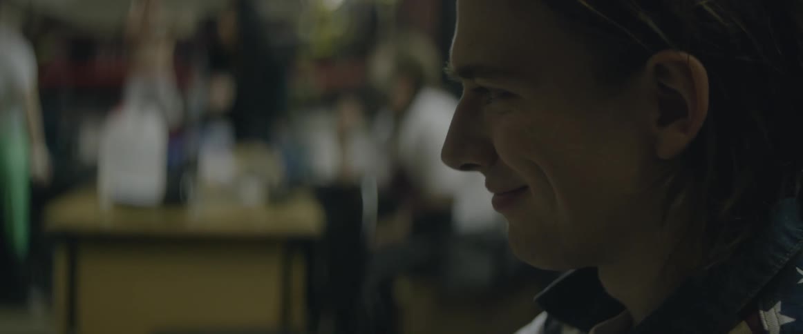 A man nods his head and smiles