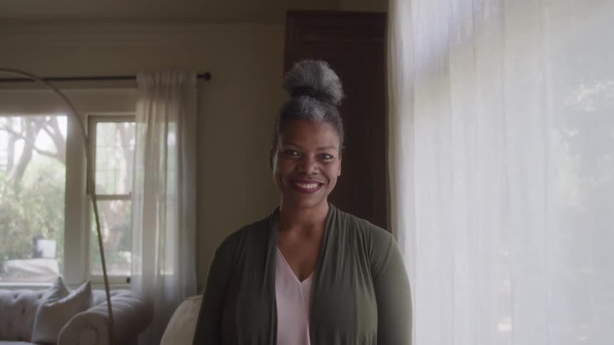 A woman smiles at the camera