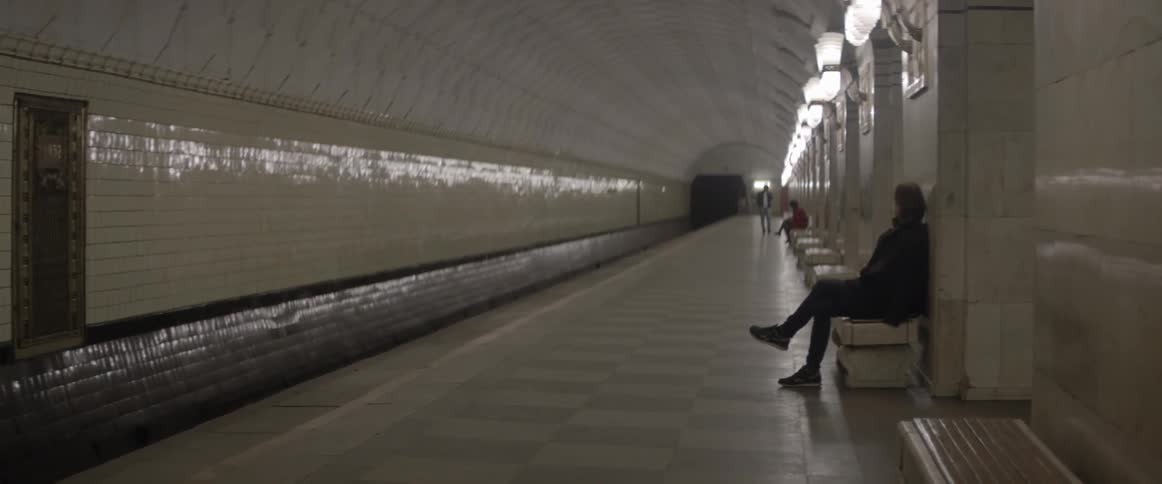 People wait in a subway station