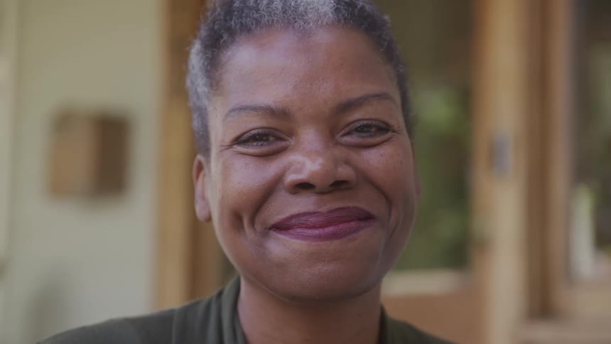 A black woman smiles looking happy
