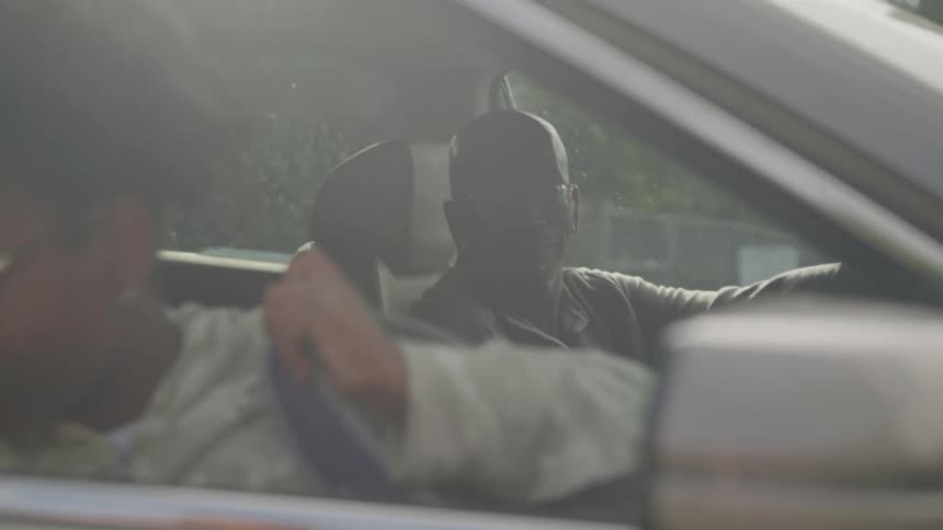 Daughter getting out of her fathers car and saying goodbye