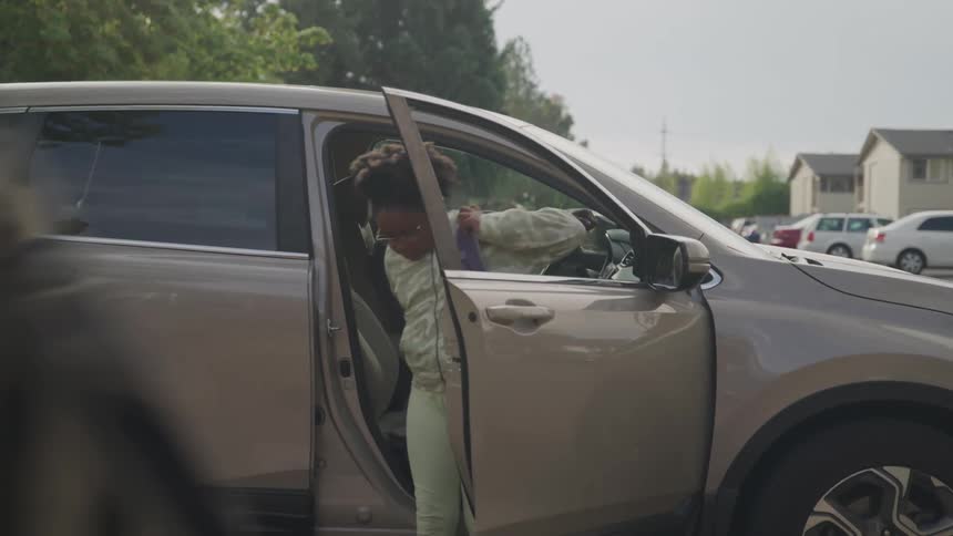 Child getting out of his fathers car and saying goodbye