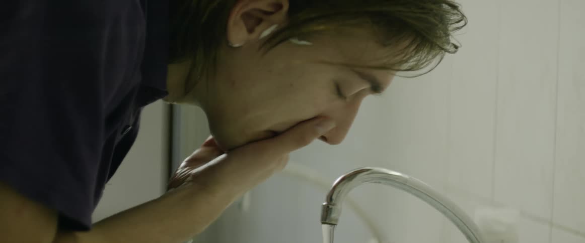 A man washes his hands