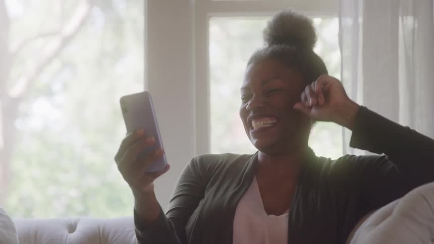 Cheerful woman chatting on video call on smartphone