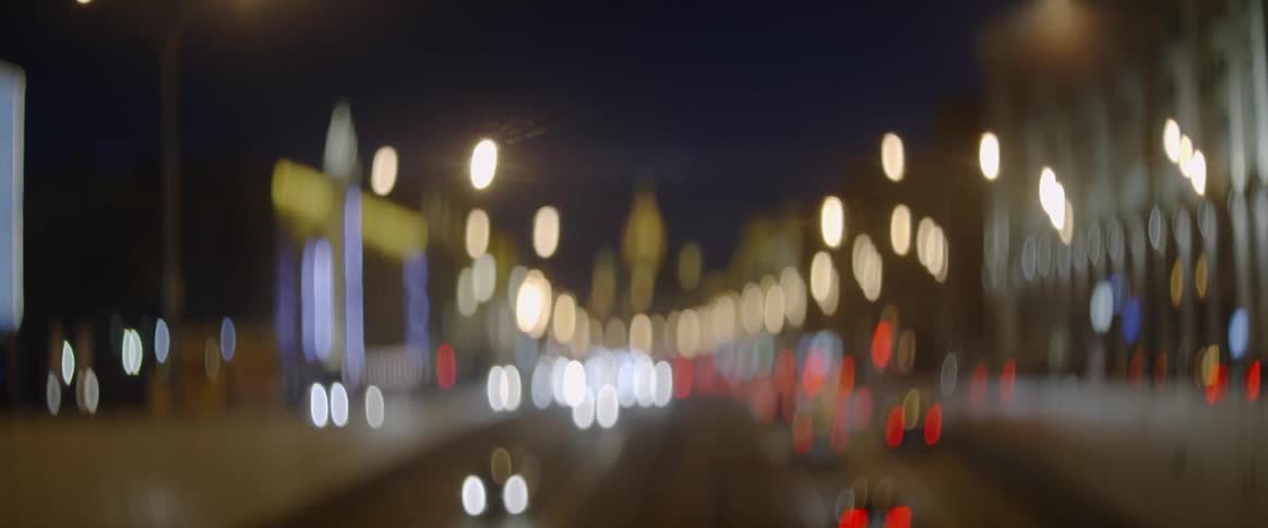 The road is busy with traffic at night