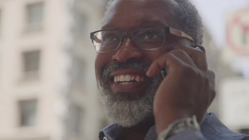 Smiling man talking on cell phone