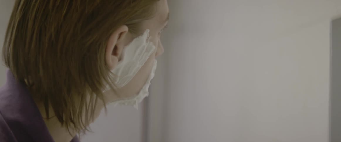 A man gives himself a shave