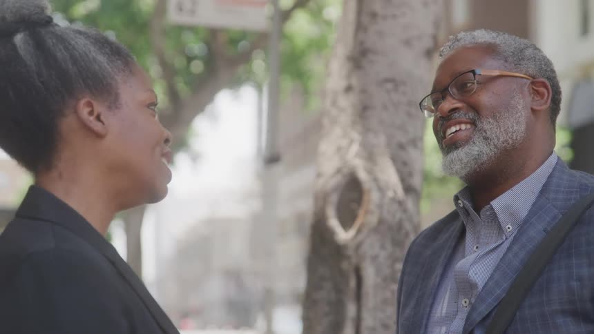 Man and woman in an outdoor environment talking smiling