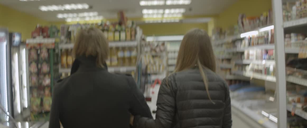 A couple are walking through a grocery store