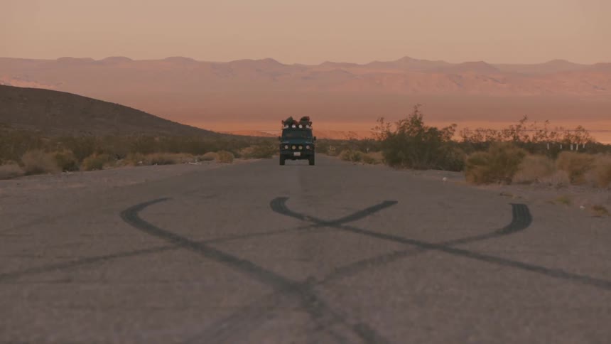 Tire marks on the street as a jeep drives toward you