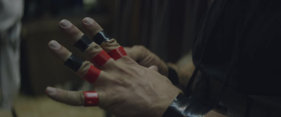 A wrestler flexes his taped fists