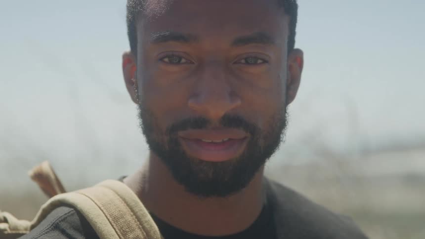 Portrait of a bearded man outdoors with a happy expression