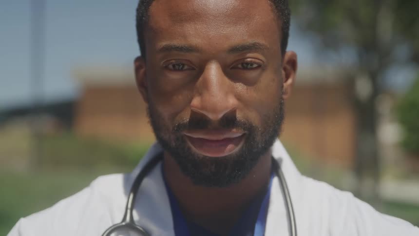 Portrait of a bearded man in a white coat