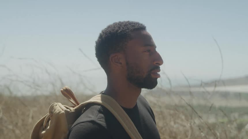 Man with a backpack enjoying the landscape in a natural environment