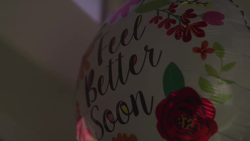 Closeup of a get well soon balloon with floral design