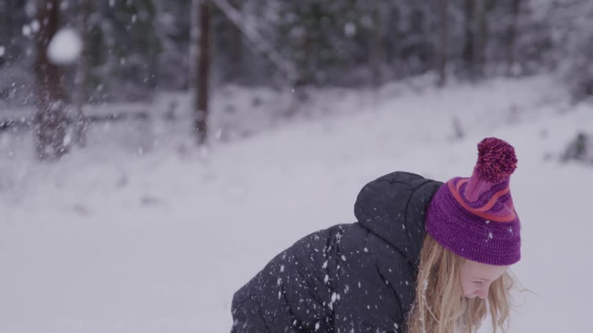 Little girl having fun playing with snow