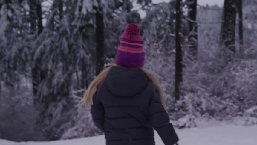 Blonde girl running in the snow
