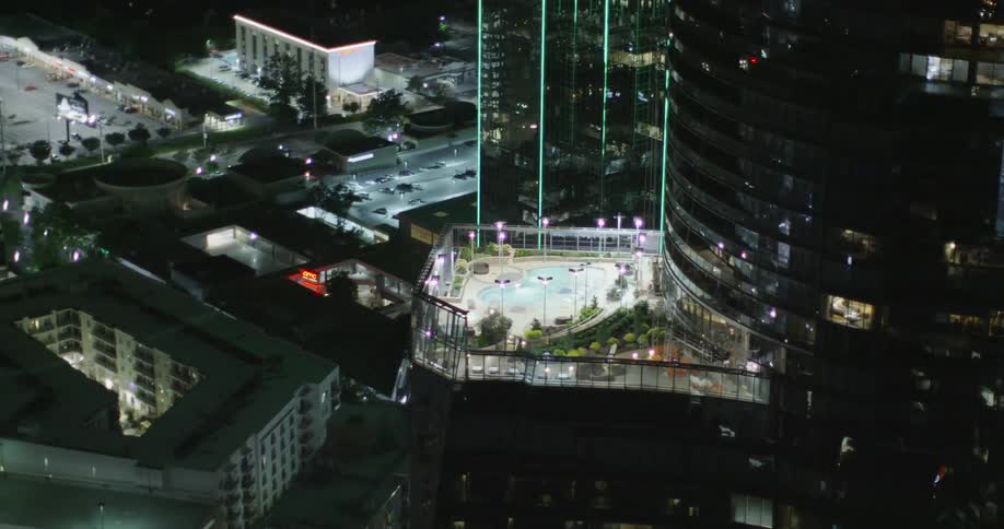 An aerial view of a city and skyscrapers at night