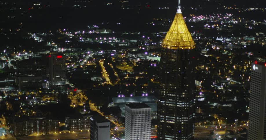 City buildings and skyscrapers are lit up at night