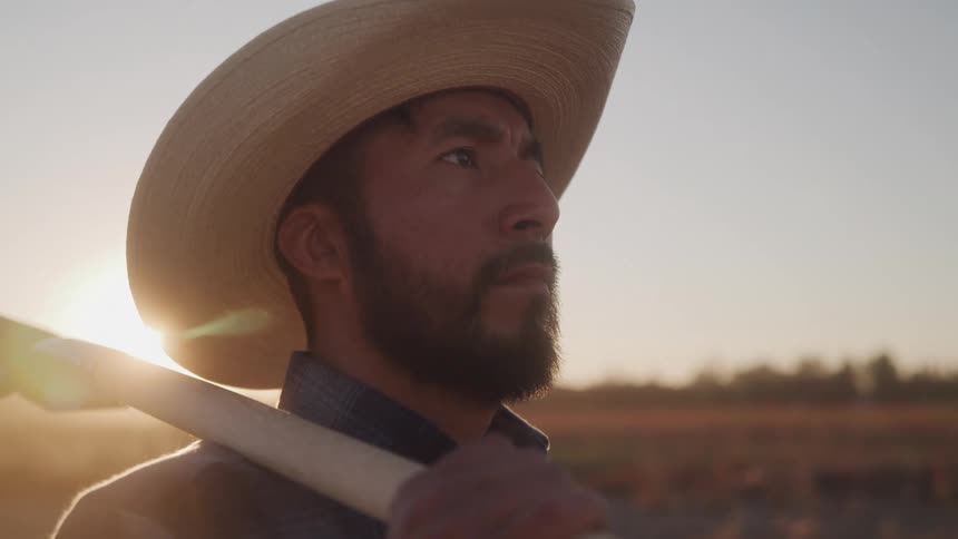 Man in farmer hat outdoors at dawn