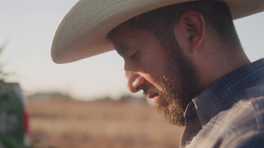 Man in cowboy hat in a field