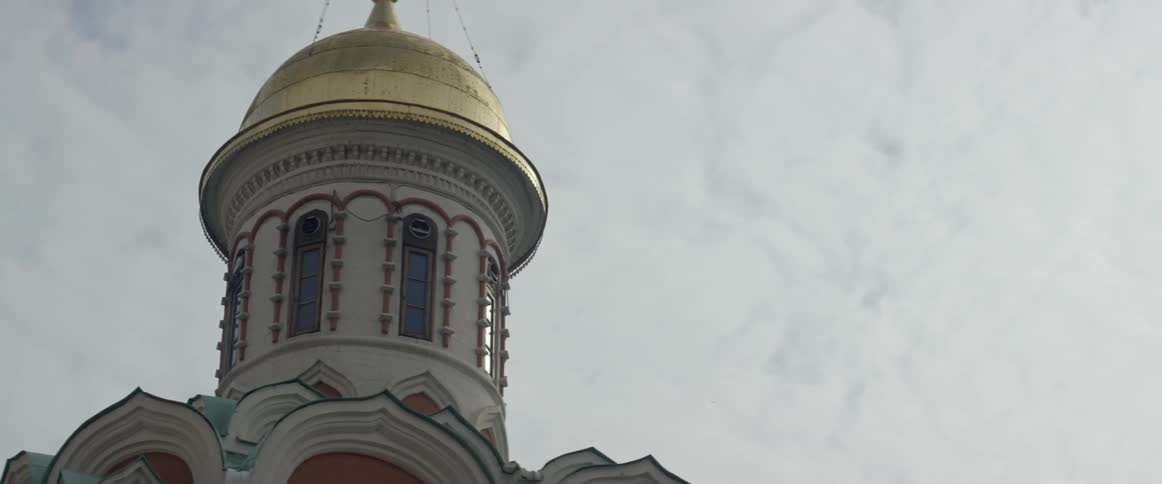 A close up view of the roof and dome of a building