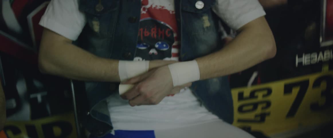 A man tapes his wrist with athletic tape