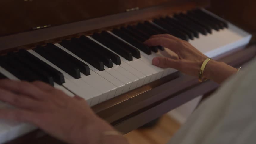 Hands of a woman playing the piano