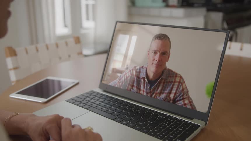 Laptop screen showing a man