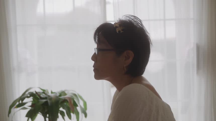 Woman with glasses in a room of the house