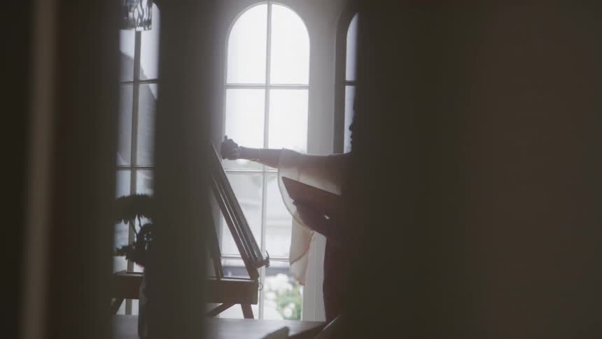 Woman in an indoor space painting a canvas
