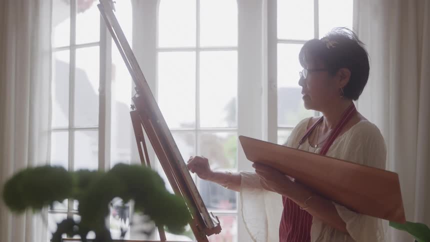 A woman sketches on a canvas