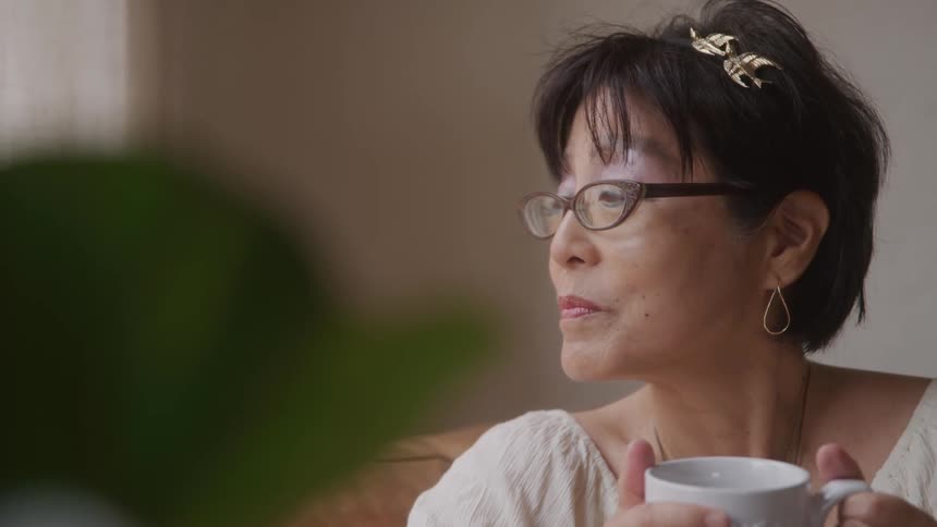 Woman sitting drinking from a mug