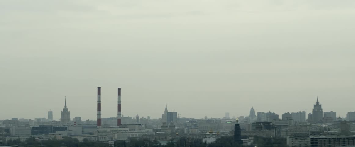 A high view of a city skyline from a distance and at a level view