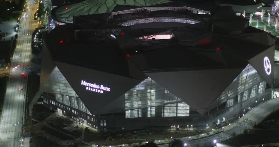 A large sporting venue is lit up at night
