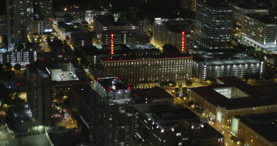 Buildings and streets have many lights turned on at night in a city