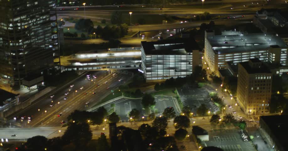 A large city filled with traffic and well lit buildings