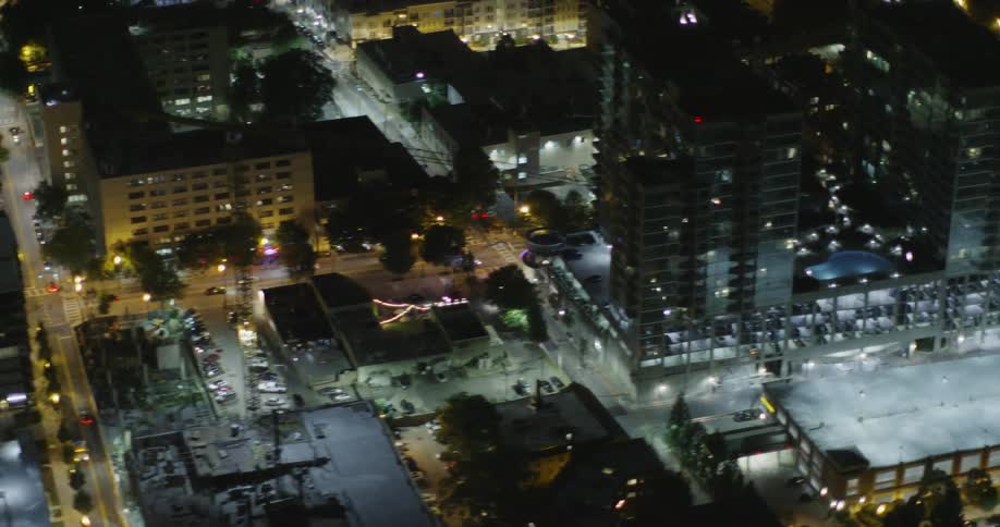 Vehicles drive along the city at night