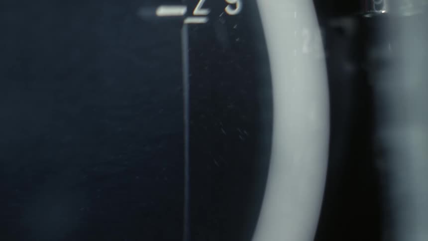 A camera lens adjustment knob moves up and down