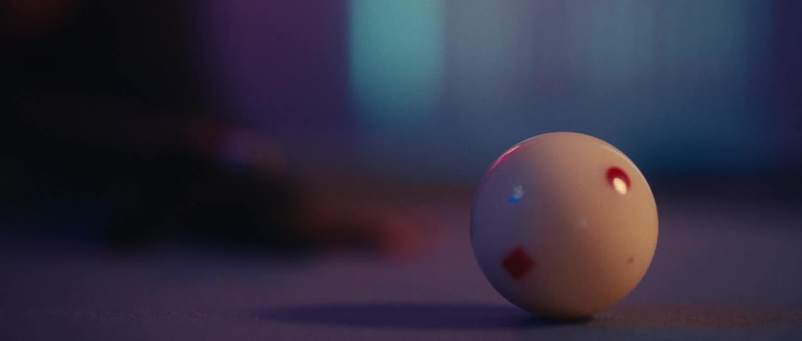 The pool ball is hit on the pool table