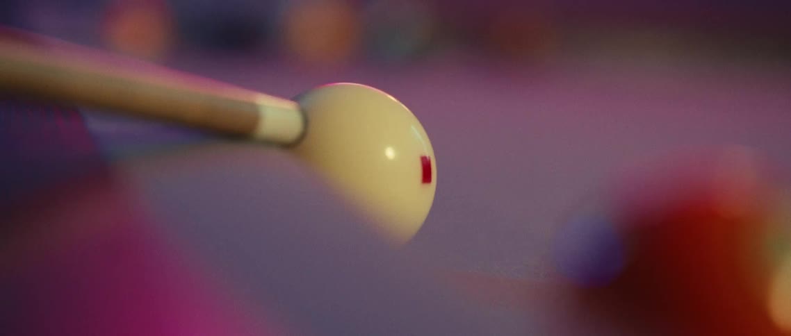 A pool cue moving back and forth then striking a pool ball