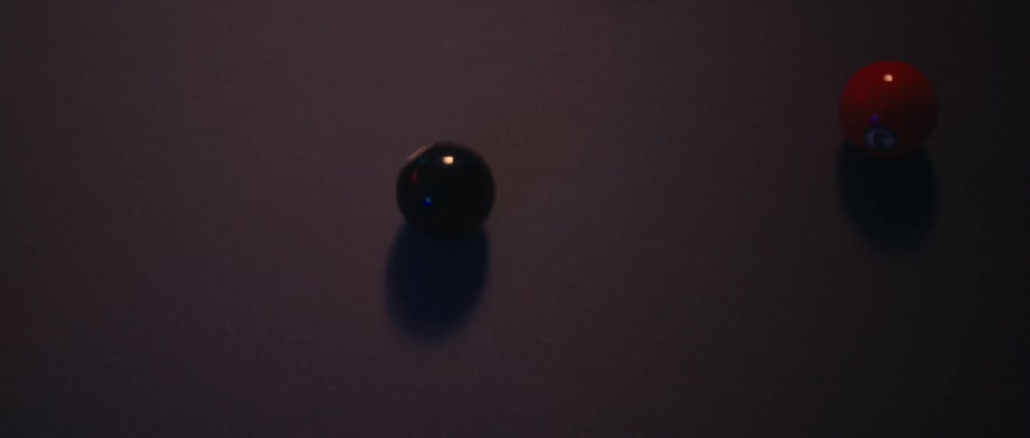 Pool balls roll across a pool table after the break shot